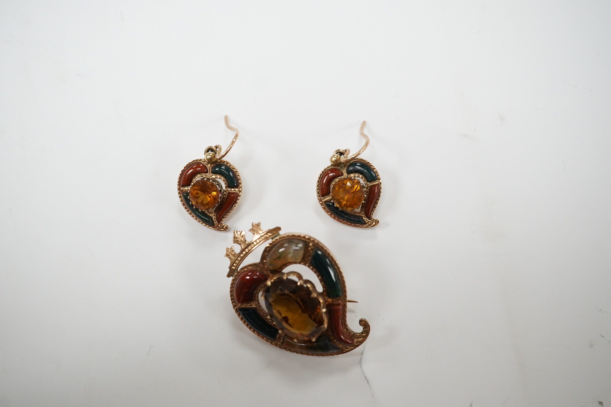 A yellow metal, Scottish hardstone and citrine set suite of jewellery, comprising a brooch, 30mm and pair of earrings, gross weight 7 grams. Condition - fair